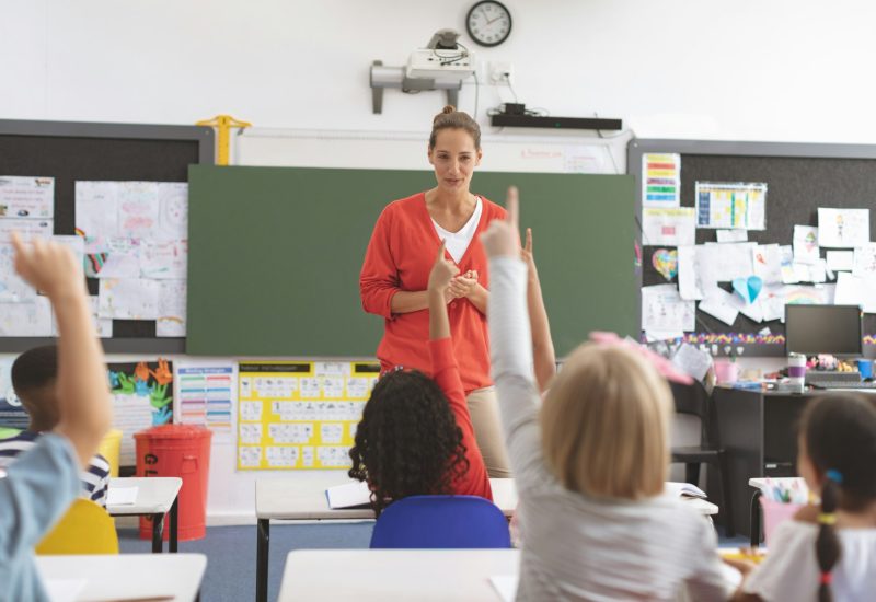 school-kids-raising-hand-to-answer-the-teacher-question-in-classroom.jpg